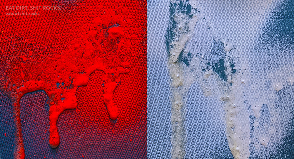 Spray paint dripping down some vinyl sheeting.